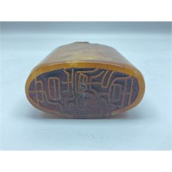 Chinese amber soapstone seal of oval form,  carved temple dog finial, inscription on the back and base, H12cm