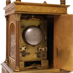 Early 20th century brass mantle clock, the face and case profusely engraved with floral scrolls, the sides inset with hunting scene panels, flanked by four Corinthian columns with acorn finials, striking the hours and halves on bell, H20.5cm W13cm