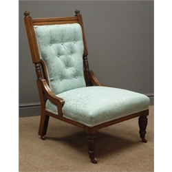 Edwardian oak framed nursing chair, upholstered in a teal fabric with floral pattern, turned supports  