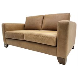 20th century two seat sofa, upholstered in tan leather with loose back and seat cushions, on stained beech tapering feet, with scatter cushions