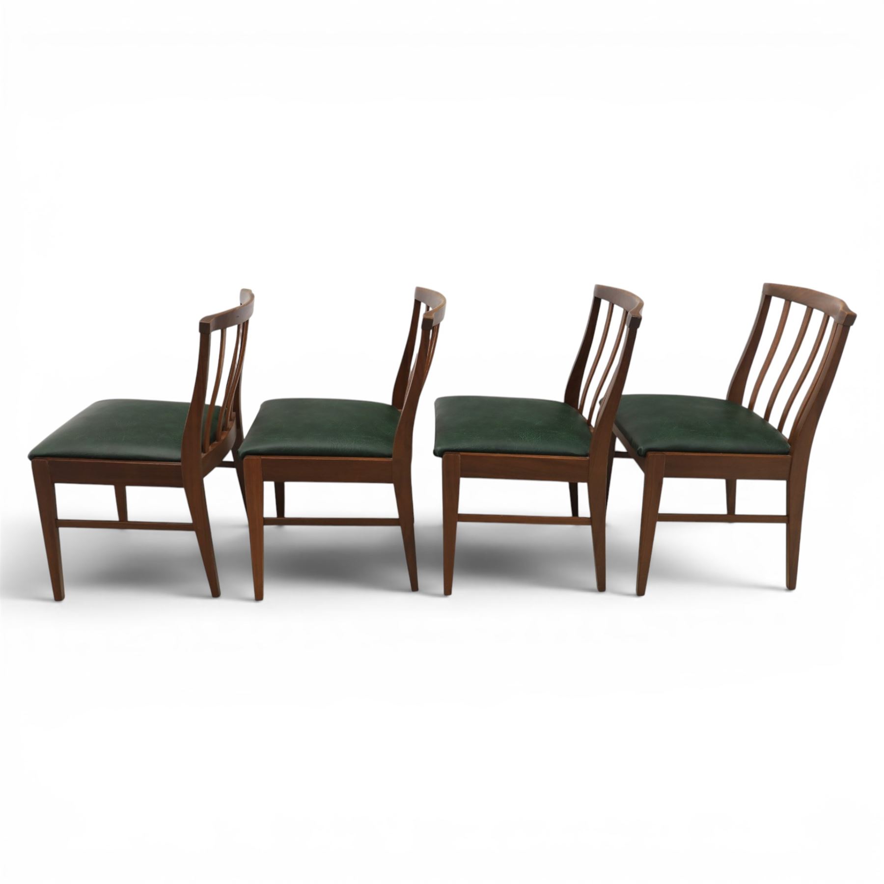 Mid-20th century teak dining table and chairs, with stowable fold over leaf, raised on square tapering legs, the chairs with teak frames and reupholstered green leather seats