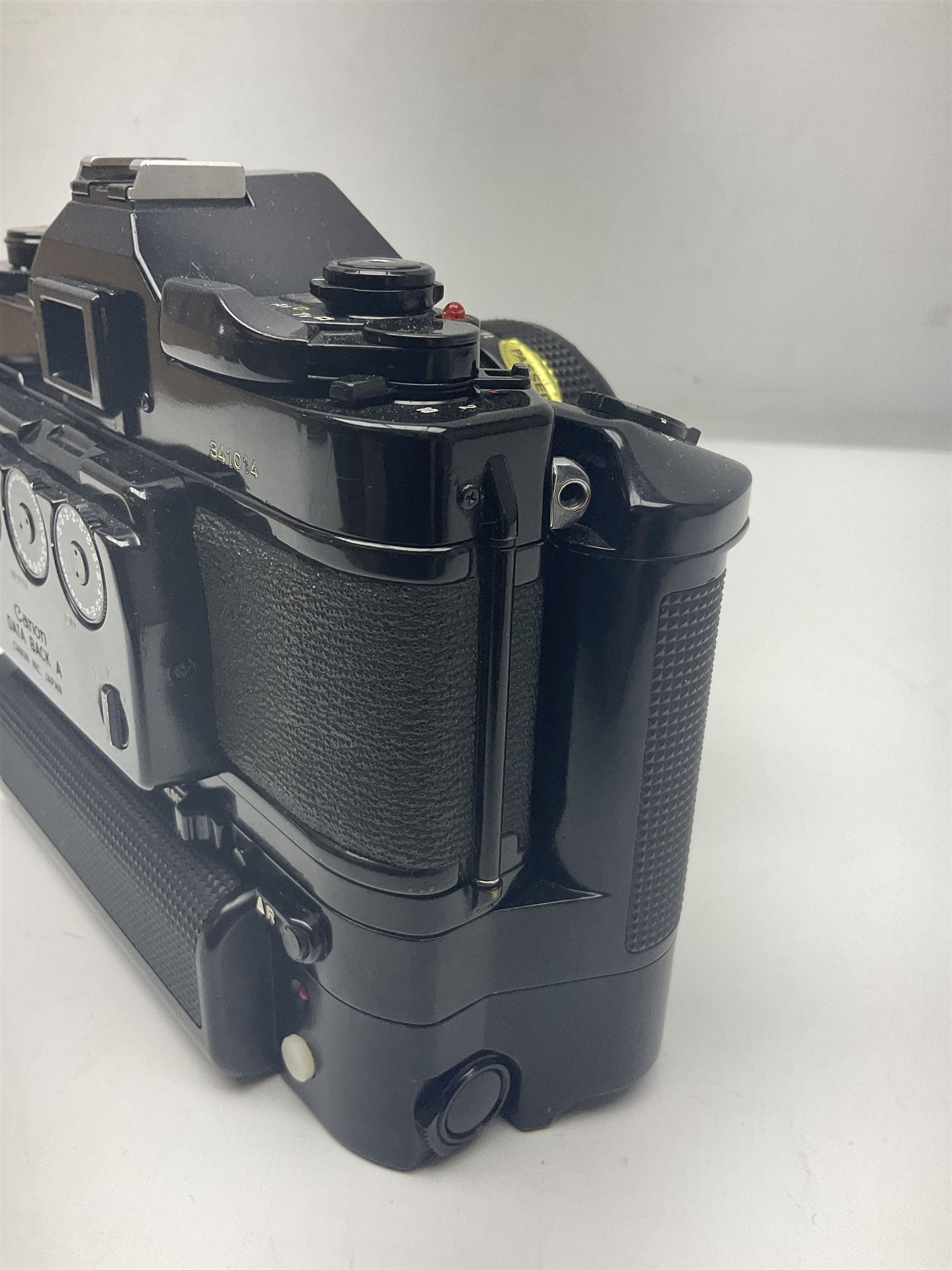 Canon A-1 camera body, serial no. 341014, with 'Canon FD 50mm 1:1.4 S.S.C.' lens, serial no. 12077119 and motor drive MA