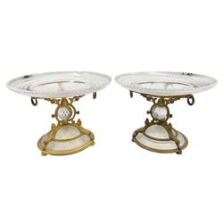 Pair of 19th century Osler glass and ormolu table centrepieces, each with circular hobnail and star cut glass dish supported upon an ormolu stand detailed with drop rings and masks, containing a central cut glass sphere, and hobnail cut dome to base, upon three compressed bun feet, each impressed Osler, D22.5cm H16cm