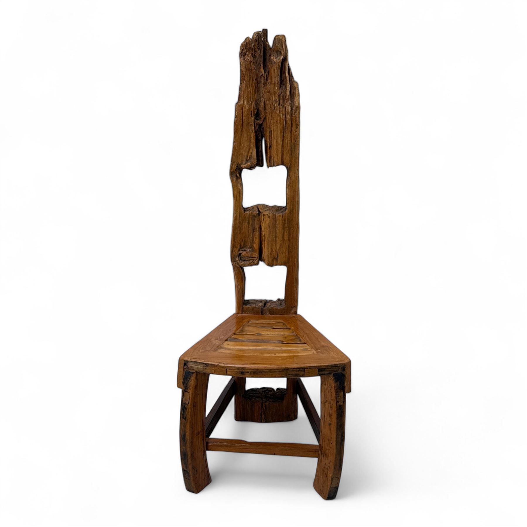 20th century driftwood sculptural hall chair, solid triangular seat over shaped apron, high ladder back formed from weathered and irregular timber, raised on curved legs united by H-stretcher