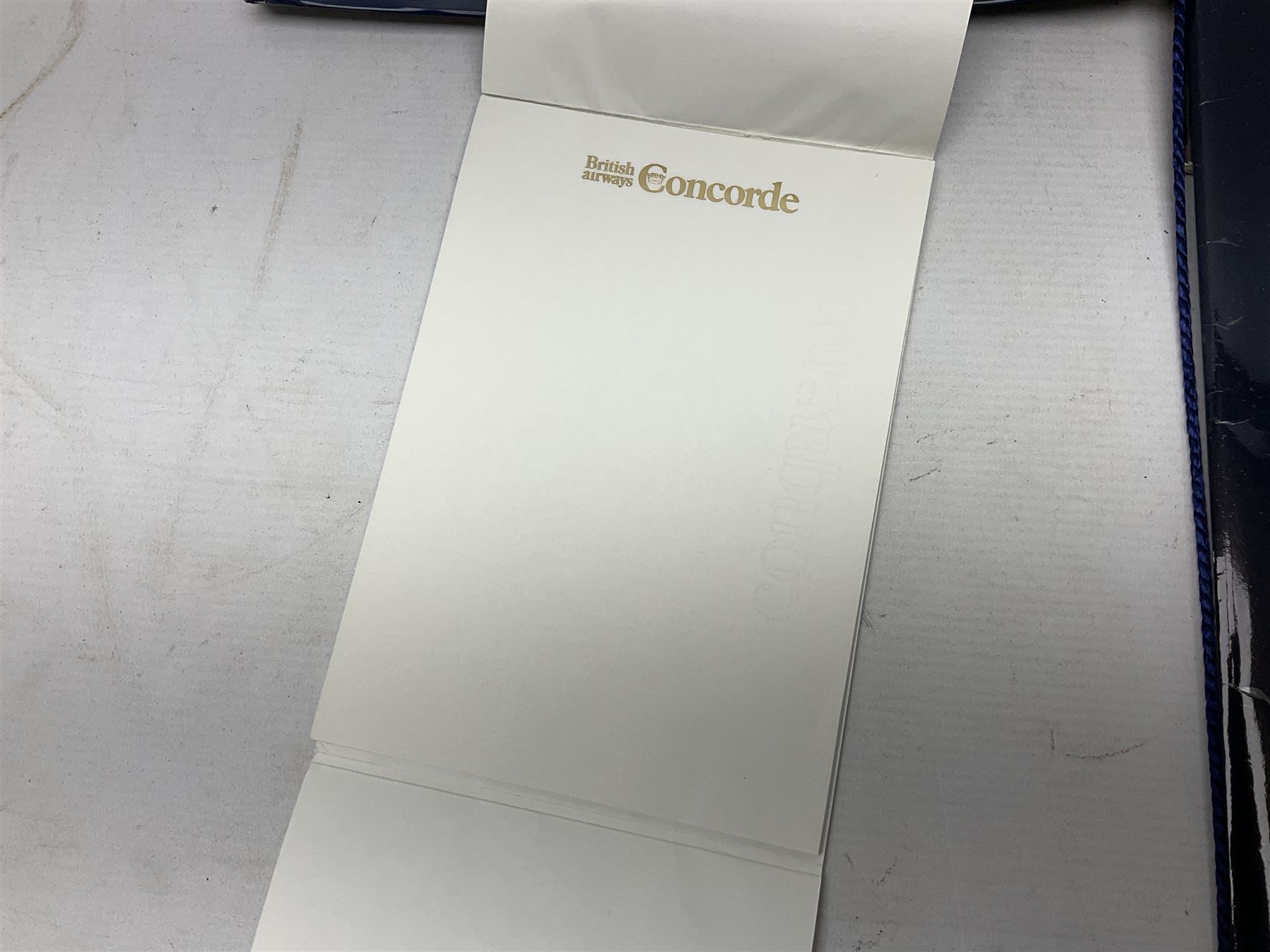 British Airways Concorde - inflight complimentary amenity pack including footwear, menu, stationery, three photographic slides, luggage label, cocktail stirrers, eye shades, fact sheet etc; in original branded blue vinyl bag with used 18th September 1977 ticket from Bahrain to London; together with a Singapore Airlines amenity kit bag with contents