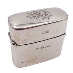 Edwardian silver travelling inkwell, of oblong form, the hinged cover with engraved monogram to top opening to reveal a gilt interior with cork section to underside of cover, and removable clear glass inkwell, hallmarked Percy Whitehouse, London 1903, H4.5cm W4.5cm, approximate gross weight (not including glass inkwell) 2.40 ozt (74.9 grams)