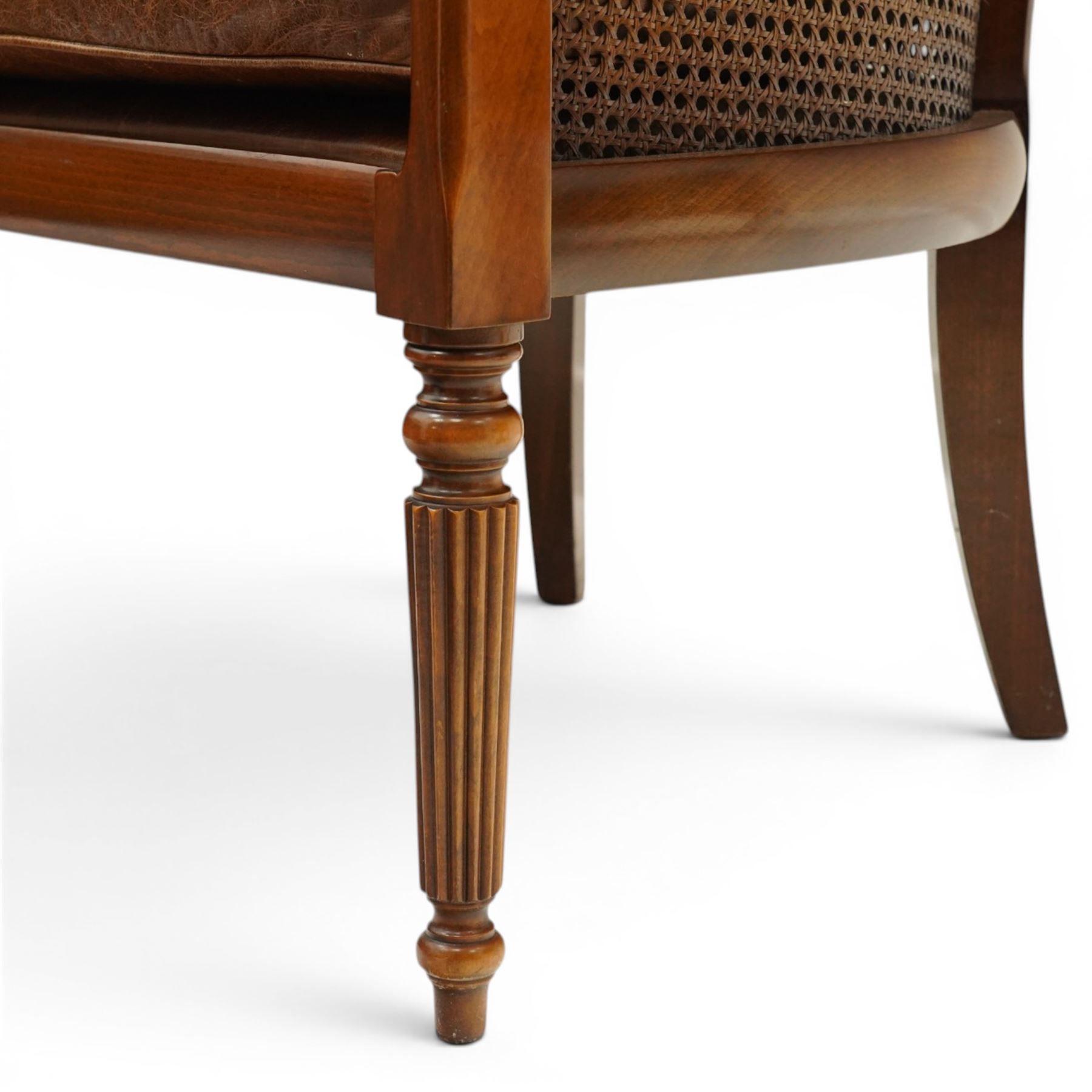 Laura Ashley - pair of bergère tub armchairs with leather seats, raised on fluted and turned supports