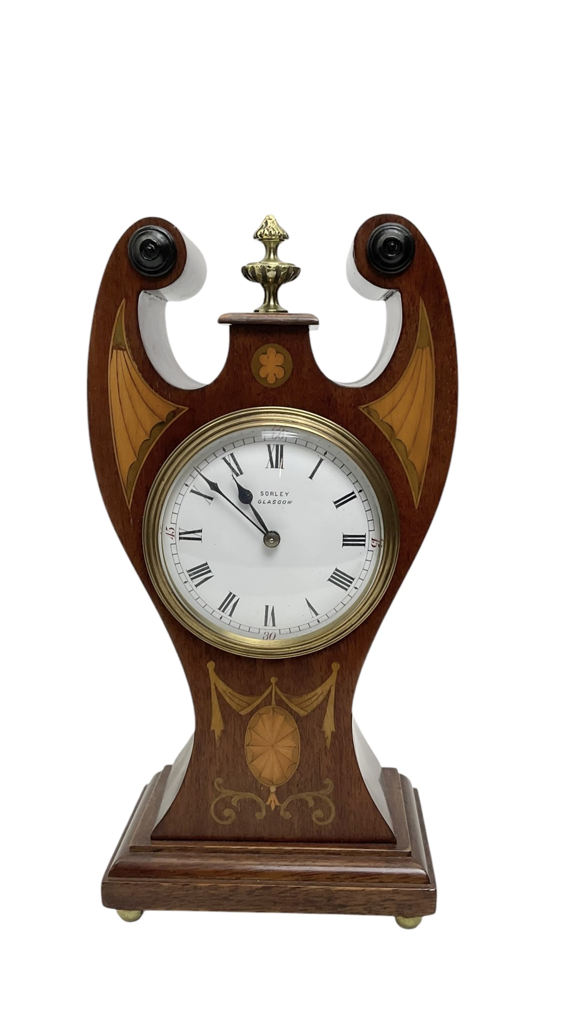 Edwardian - Art Nouveau 8-day mantle clock c1910, with waisted mahogany case, fine inlaid marquetry work and cast brass finial, white enamel dial with Roman numerals, minute track, spade hands and retailers name (Sorley, Glasgow) within a cast brass bezel and convex glass, French single train movement and platform escapement, wound and set from the rear.  