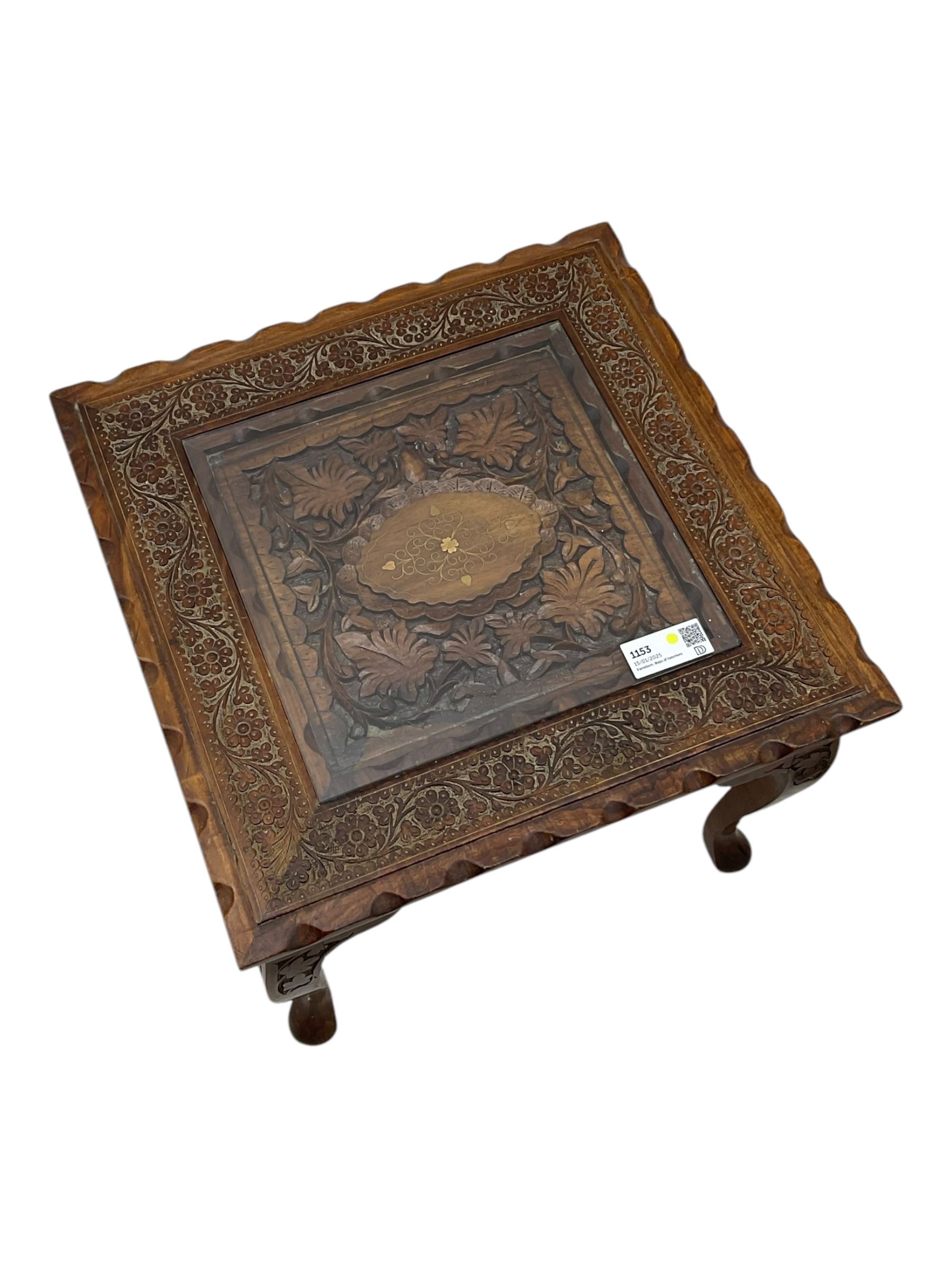 Pair of Pakistan carved hardwood brass inlaid lamp tables, square form, cabriole legs, inset glass tops