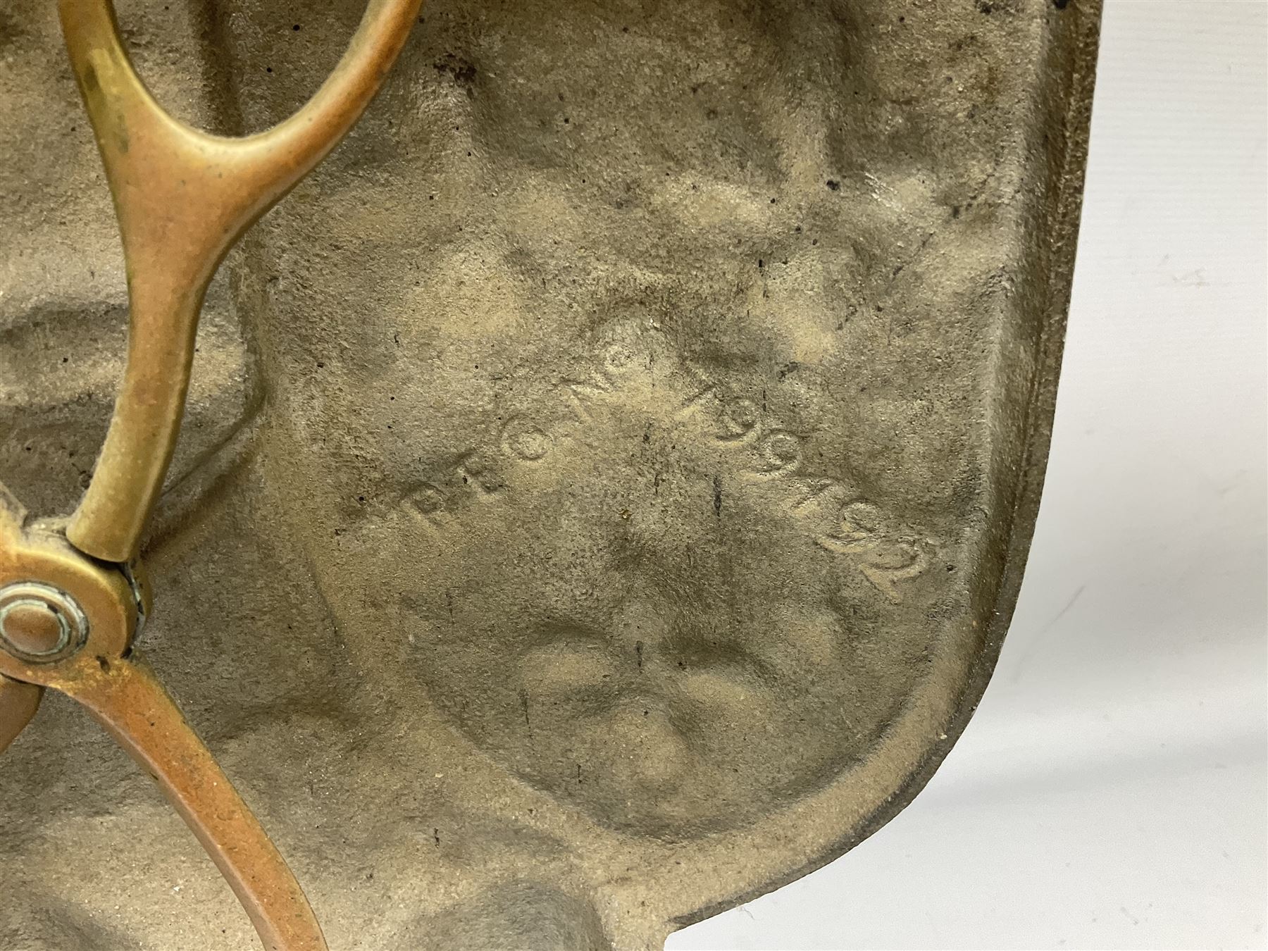 Cast iron fire companion set modelled as a knight in armour with fleur-de-lis shield and sword concealing fire poker, with brass tongs to reverse, raised upon stepped rectangular base, H55cm