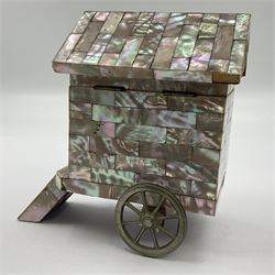 19th century French souvenir jewellery casket in the form of a bathing machine, having mother of pearl panelled tiled effect body, hinged roof/cover revealing a blue silk fitted interior with cushioned base, two silvered metal wheels, abalone shell door and mother of pearl steps, inscribed 'Berck Plage' in blue, H12cm, W13cm 