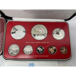 Four Papua New Guinea proof eight coin sets, from ten kina to one toea, comprising First Coinage of Papua New Guinea 1975 proof set, 1976, 1977, and 1979 proof sets, the 1977 and 1979 sets containing 925 silver ten kina and 500 silver five kina coins, all minted at the Franklin Mint, cased with certificates (4)