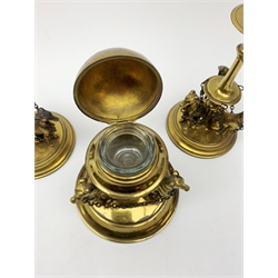 19th century gilded desk set, comprising pair of candlesticks and globular inkwell, each detailed with seated hounds to the stepped circular bases, candlesticks H19cm, inkwell H12cm