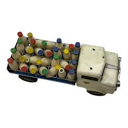 1950s Triang pressed steel milk float, containing twenty eight plastic milk bottles with coloured tops, together with a 1950s Triang pressed steel locomotive 'Triang Express', tallest H21cm