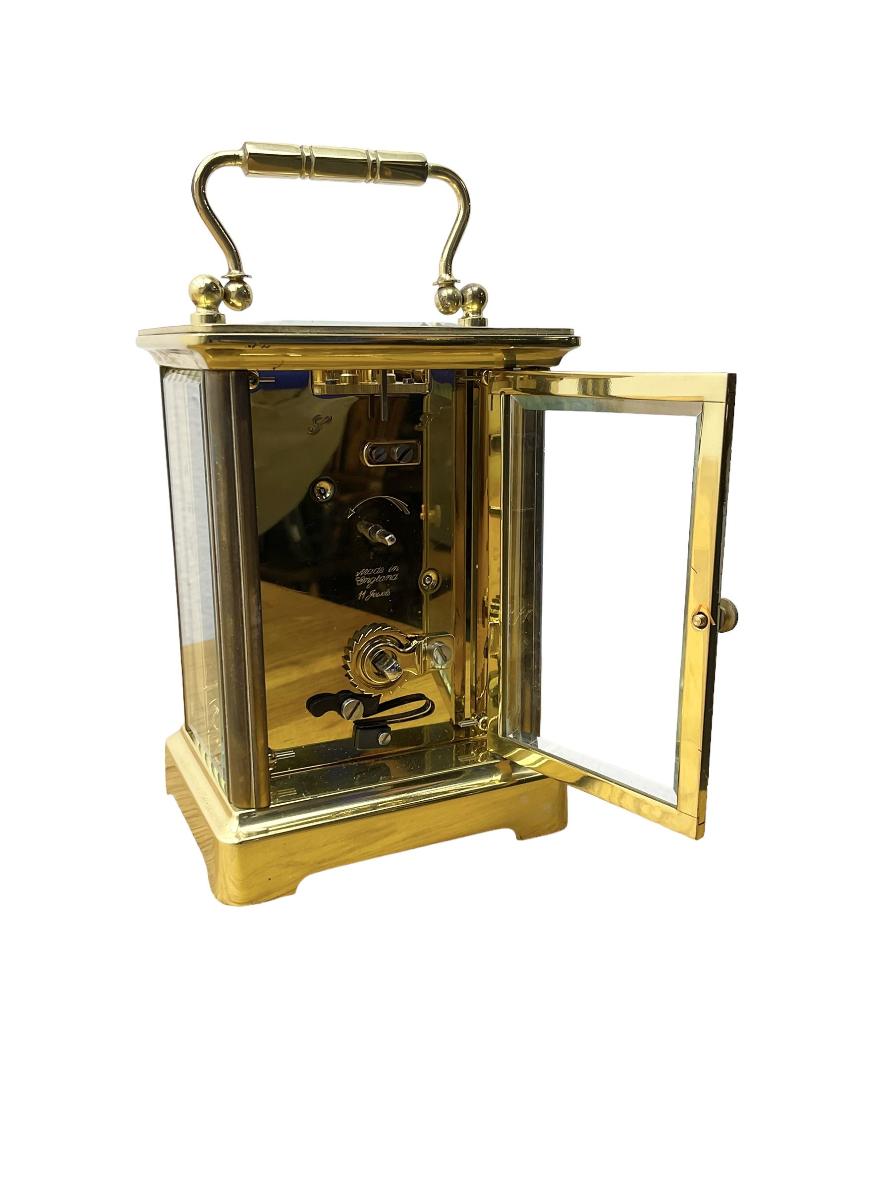 Taylor & Bligh - English 8-day carriage clock in a corniche-style case, white dial with roman numerals and steel moon hands, 11 jewel movement with a lever platform escapement. With key.