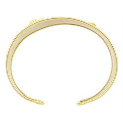 18ct gold 'Love' torque bangle, set with a heart cut pink sapphire and blue topaz, stamped Sidra 750