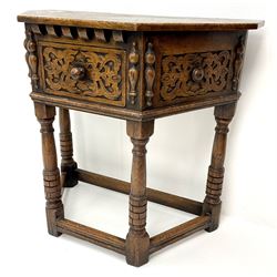 20th century oak credence table, canted top over single drawer, the front relief carved with scrolled leafage, split turned mounts, turned supports joined by moulded stretchers