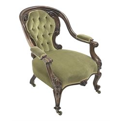 Victorian rosewood open armchair, shaped and moulded down swept frame, the back carved with a series of c-scrolls, scrolled and floral carved arm supports and cabriole feet with scroll carved terminals, upholstered in deep green buttoned fabric, brass castors
