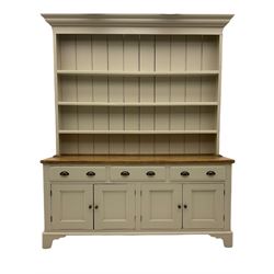 Victorian pine dresser, raised painted three heights plate rack with projecting cornice, waxed top over pained base fitted with three drawers and two double cupboards, bracket feet
