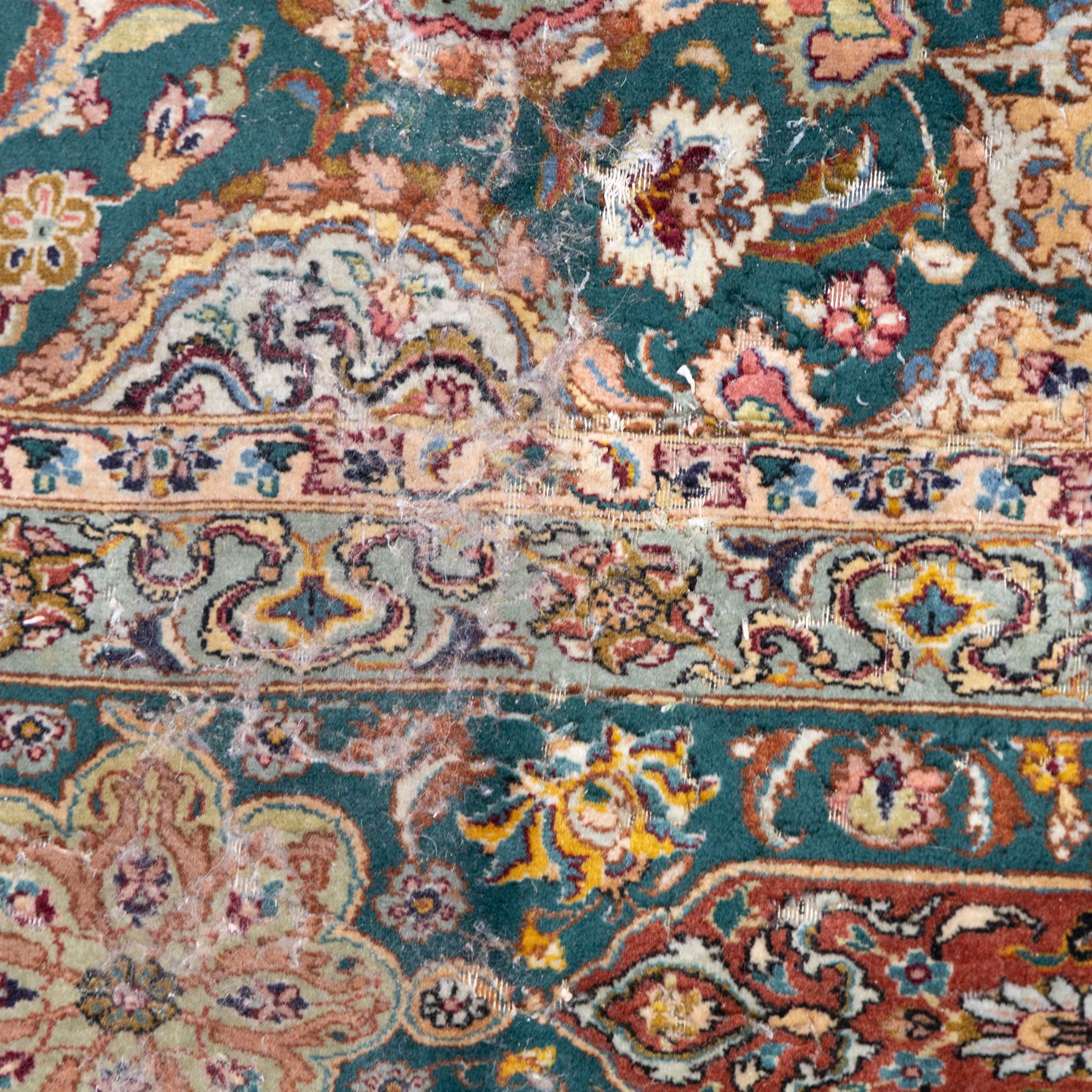 Persian Tabriz type carpet, the teal ground decorated with central medallion, radiating palmettes and dense floral scrollwork, within multiple floral borders