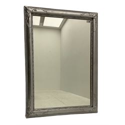 French style rectangular mirror, in rounded silvered frame decorated with scroll foliage and beading 