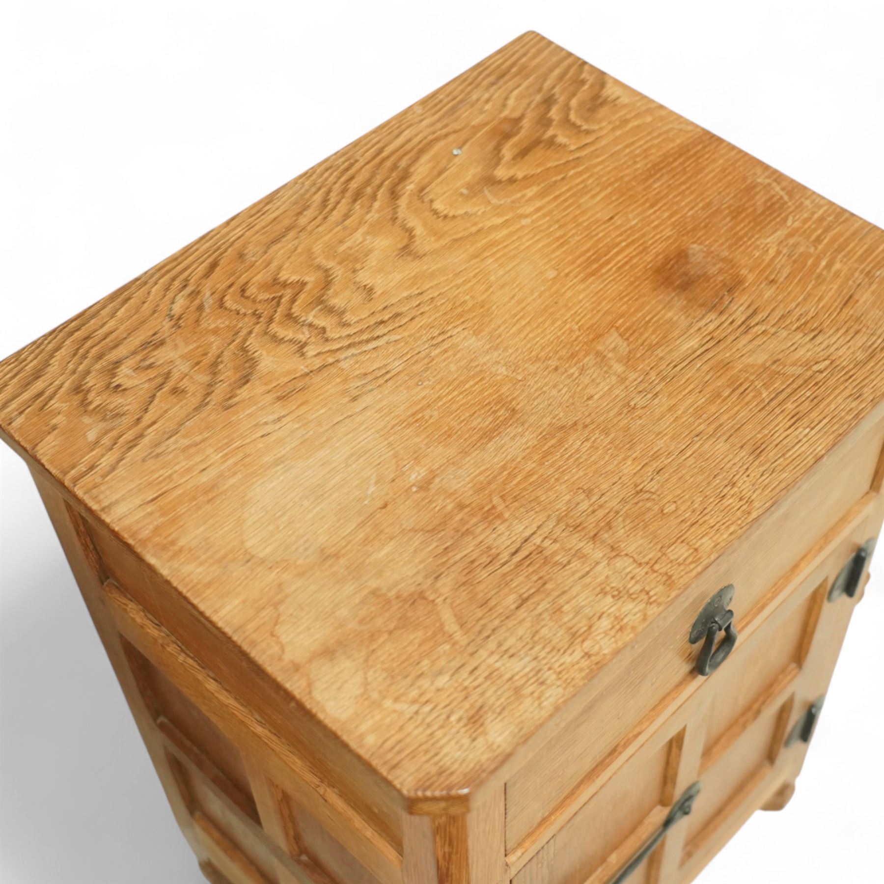 Beaverman - pair of oak bedside cabinets, each with plain rectangular top over single drawer and cupboard below with fielded panels and wrought iron hardware, with signature carved beaver, by the workshop of Colin Almack, Thirsk