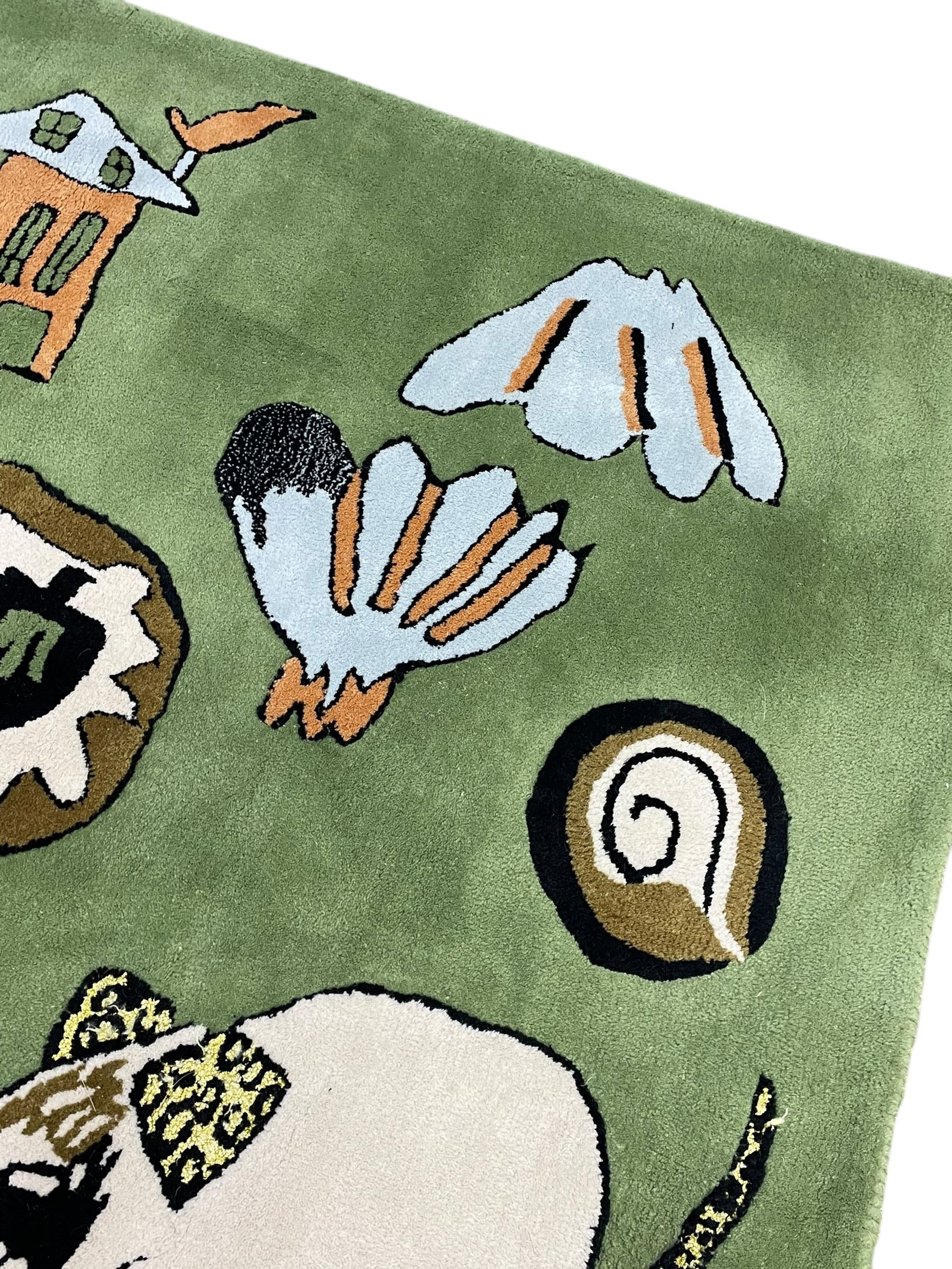 Shrimps for Habitat - 'Wilder' hand tufted green ground rug decorated with abstract motifs of animals, faces, shells and houses 