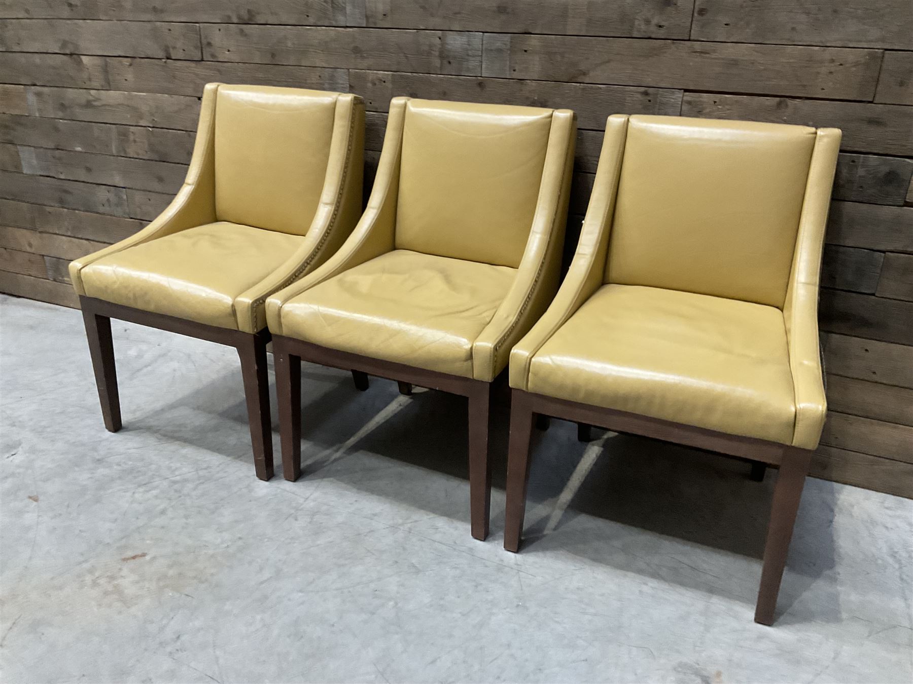 3 x walnut framed dining chairs, upholstered in a dark beige leather