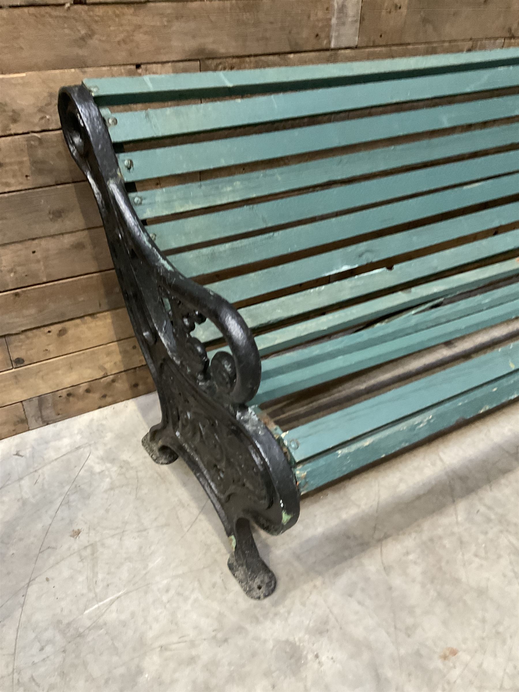 Early 20th century slatted garden bench with scrolling cast iron bench ends