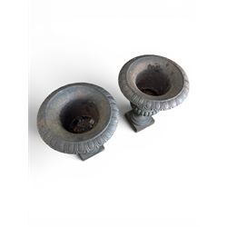 Pair of Victorian design heavy cast iron garden urns, black painted, egg and dart rim on waisted column