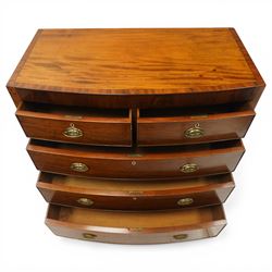 Early 19th century Regency mahogany bow-front chest, with banded caddy top and ebony stringing, fitted with two short over three long cockbeaded drawers, with oval brass handles, shaped apron and splayed bracket feet