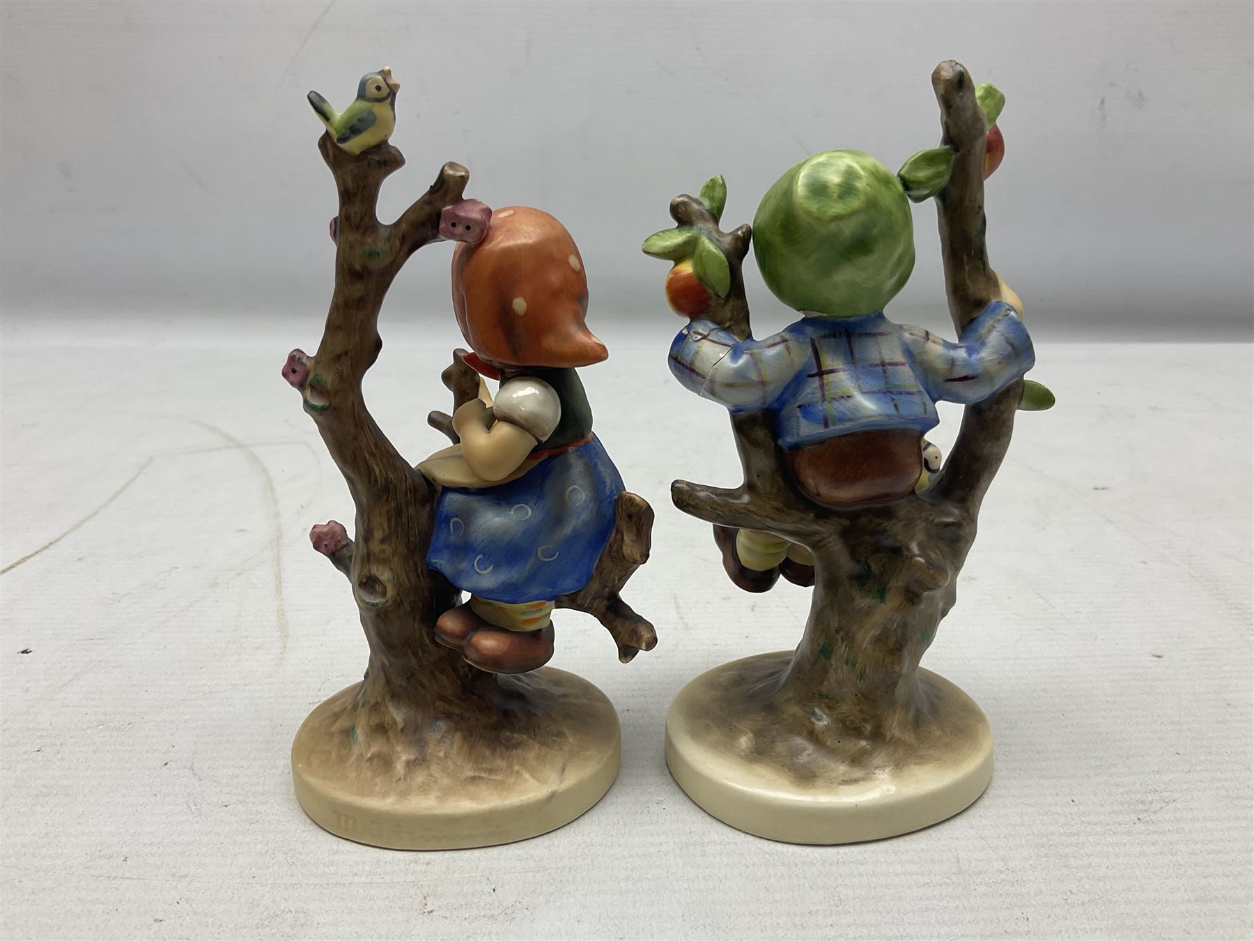 Seven Goebel Hummel figures, comprising Chimney Sweep 12/I, Apple Tree Girl 14/I, Apple Tree Boy,  Little Goat Herder 200/I, Surprise 94 3/0, Signs of Spring 203/20 and Wayside Harmony 111/30, tallest H15cm