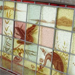 Large Victorian Aesthetic movement stained glass leadlight window panel, hand painted with a scene of herons and other birds in a lake, overall 82cm x 147cm 