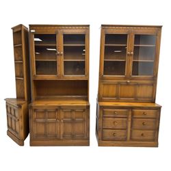 Ercol - mid-20th century dark elm 'Old Colonial' three sectional wall display unit, comprising two units and corner unit, fitted with open shelves, glazed cupboards and drawers