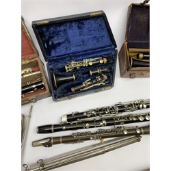  Six clarinets comprising Hawkes & Son No. 9026 in leather case, unmarked E-flat bakelite, Hawkes & Son B-flat No. 8854, Corton B-flat No. 550 in wooden box, Penzel Bros. New York B-flat and Rampone Milano E-flat in associated case, three lacking mouthpiece and connector and a folding music stand  