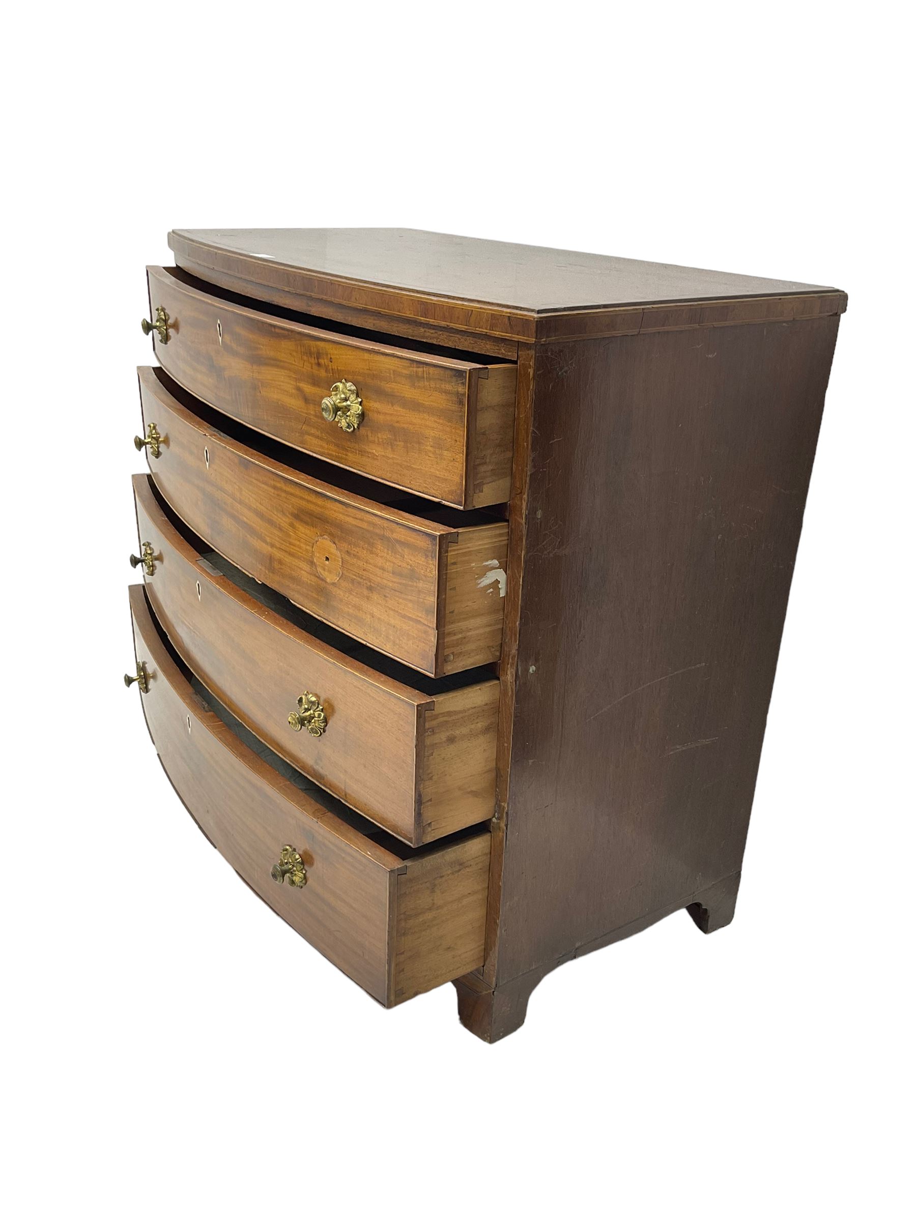 Regency mahogany bow front chest, the top with ebony and satinwood stringing, fitted with four cockbeaded drawers with brass pull handles and bone escutcheons, on bracket feet
