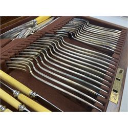 Elkington & Co part canteen of silver plated and stainless steel cutlery, to include simulated ivory handled examples, housed in oak and mahogany case, lock plate stamped 'Acme, British Made', W49cm D31cm H18cm