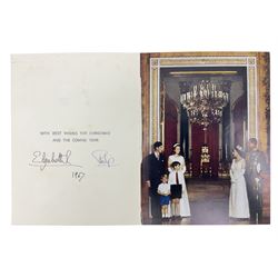 HM Queen Elizabeth II and HRH the Duke of Edinburgh, 1967 Christmas card with two gilt cyphers to front, tipped-in colour print of the Royal Family standing under an archway in Buckingham Palace, signed Elizabeth R and Philip with manuscript date 1967 below