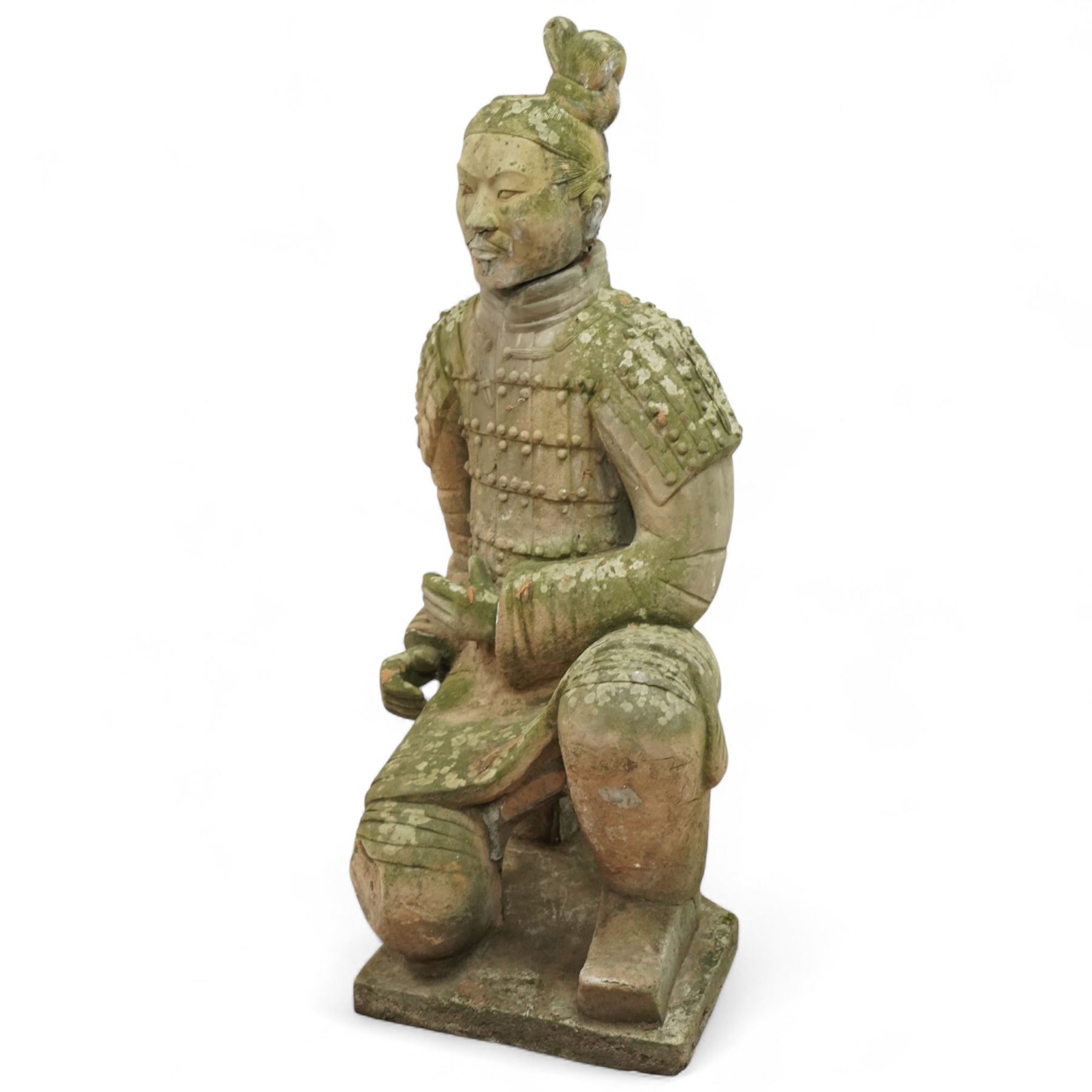 Two near life-size terracotta warrior figures, modelled in the style of the Qin dynasty soldiers, each kneeling with one arm raised, wearing detailed armour and tunics, one example partially damaged and lacking sections