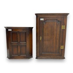 Early 20th century wall mounted oak corner cabinet, moulded cornice over panelled door enclosing single fixed shelf (W60cm, D40cm, H66cm); 19th century oak corner cabinet, panelled door enclosing three shaped shelves (W65cm, D35cm, H92cm)