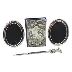 Pair of modern silver mounted photograph frames, of plain oval form, inscribed 'Concorde', hallmarked British Airways, Sheffield 1990, overall H11cm, together with a modern silver mounted address book embossed with a courting couple within a scroll surround, hallmarked London 1991, makers mark DP, and a modern silver Royal Commemorative letter opener the terminal modelled as Prince of Wales feathers, hallmarked Parkin Silversmiths Ltd, Sheffield 1988