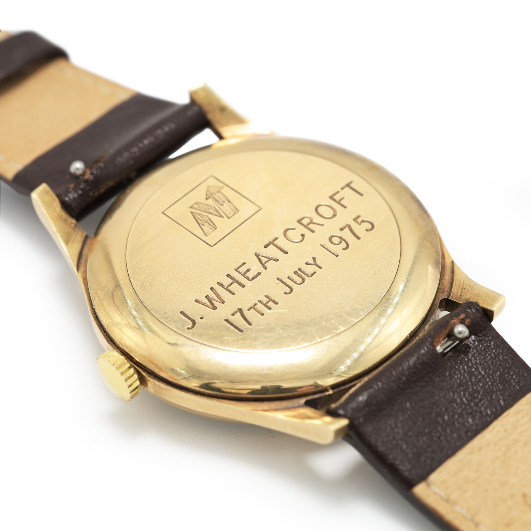 Garrard gentleman's 9ct gold manual wind wristwatch, silvered dial with Arabic hour markers and subsidiary seconds dial, the back case with personalised engraving, London 1974, on brown leather strap