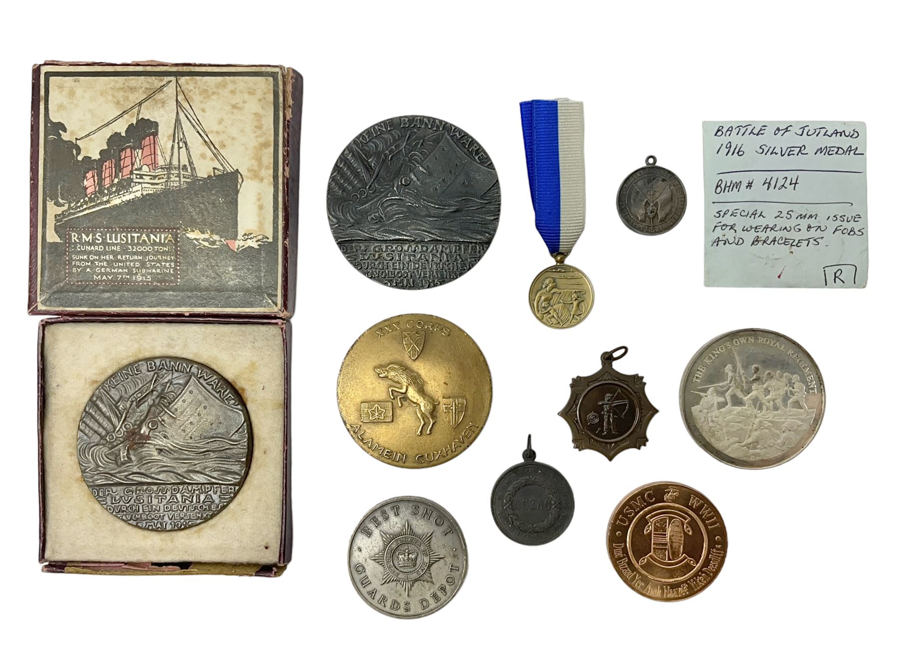 RMS Lusitania iron medallion dated 5th May, 5.5cm diameter, boxed with St Dunstan's Blinded Soldiers Profit paperwork; another unboxed similar Lusitania medallion; 30th Corps Alamein Cuxhaven medallion; Battle of Jutland 1916 silver memorial pendant; Navajo Code Talkers medallion 2000; and five other military related medallions
