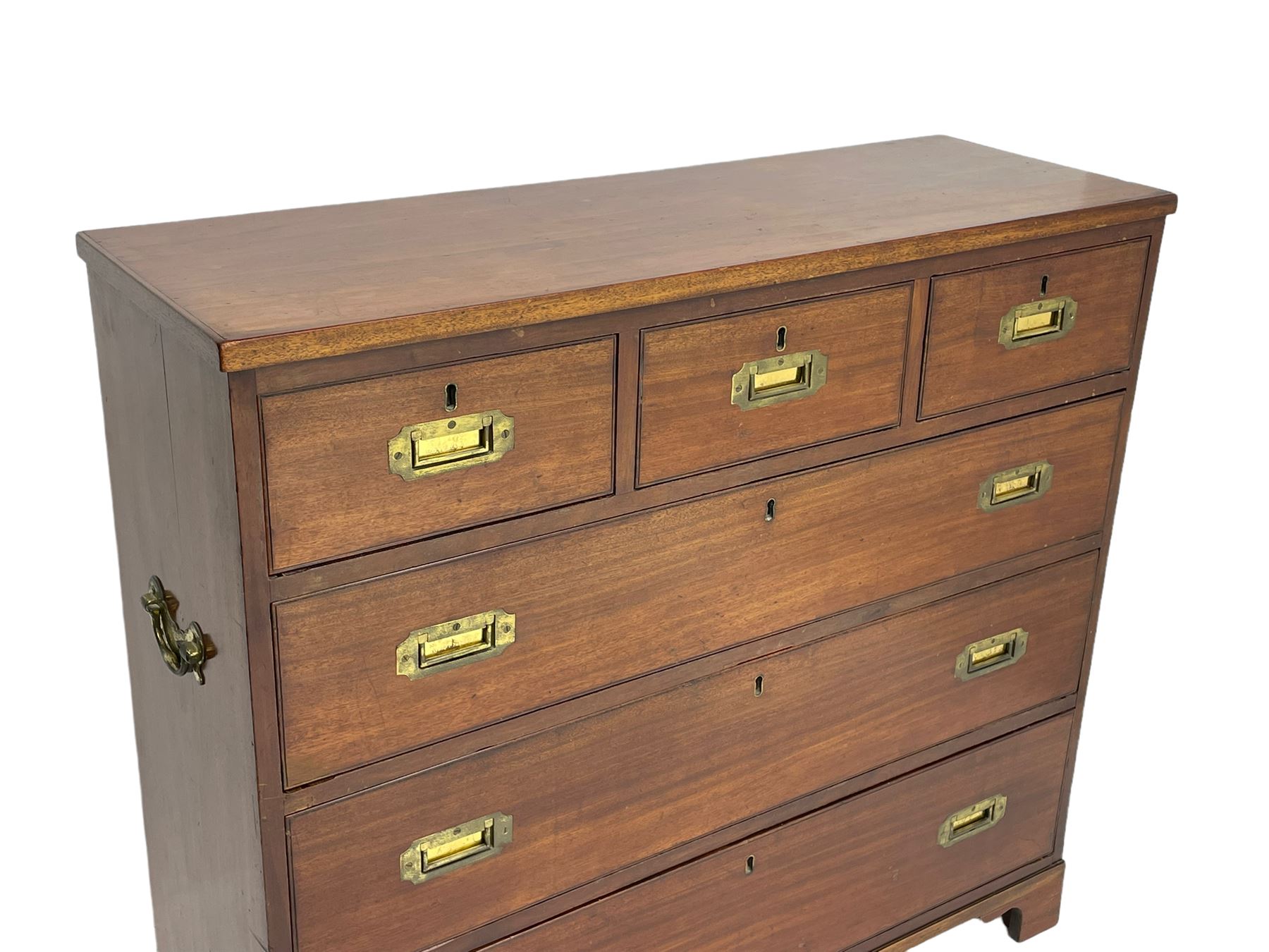 Georgian military type campaign chest, narrow rectangular top over three short and three long drawers, recessed brass handles, on bracket feet