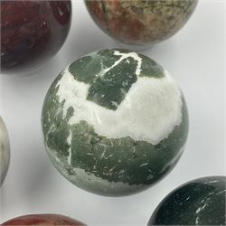 Eight mineral specimens spheres, comprising jasper red, spotted agate, unakite, sardonyx, petrified wood, Serpentine, Larvikite and green Aventurine 