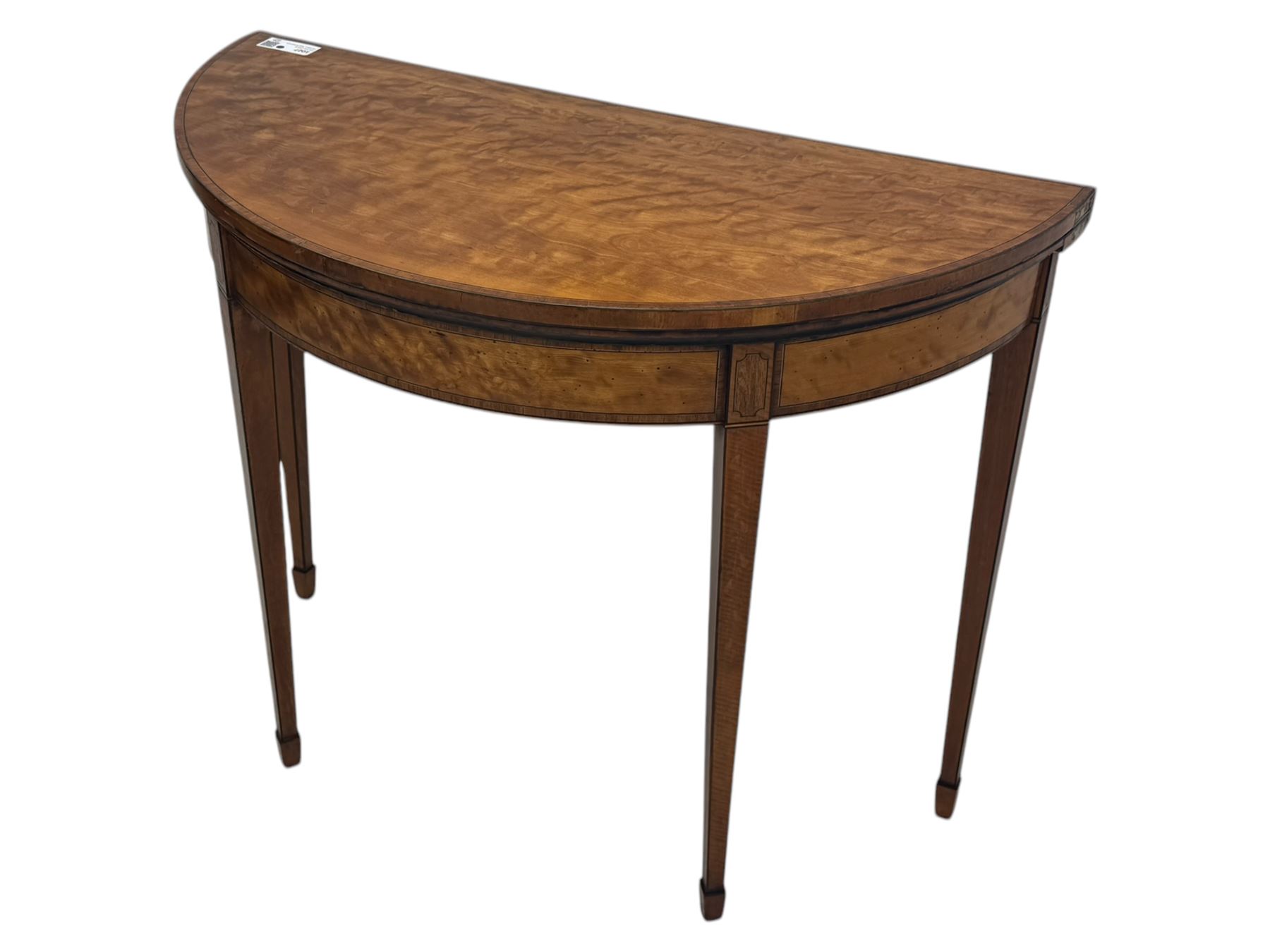 Edwardian satinwood inlaid demi-lune card table, hinged fold over green baize lined interior, raised on square tapered supports with spade feet  