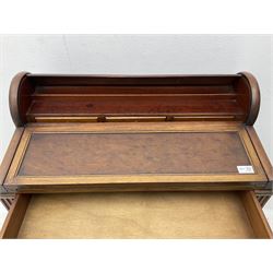 Early 20th century French plum pudding mahogany petite writing desk, barrel tambour roll top, fitted with a single cock-beaded drawer activating the tambour roll, the fold-over writing slope with inset writing surface supported by long drawer, fitted with three small drawers and pen rail, raised on fluted tapering supports