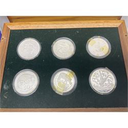 The Royal Mint 'Conservation Coin Collection' formed of twenty-four silver proof coins, housed in the wooden display case, with information booklet