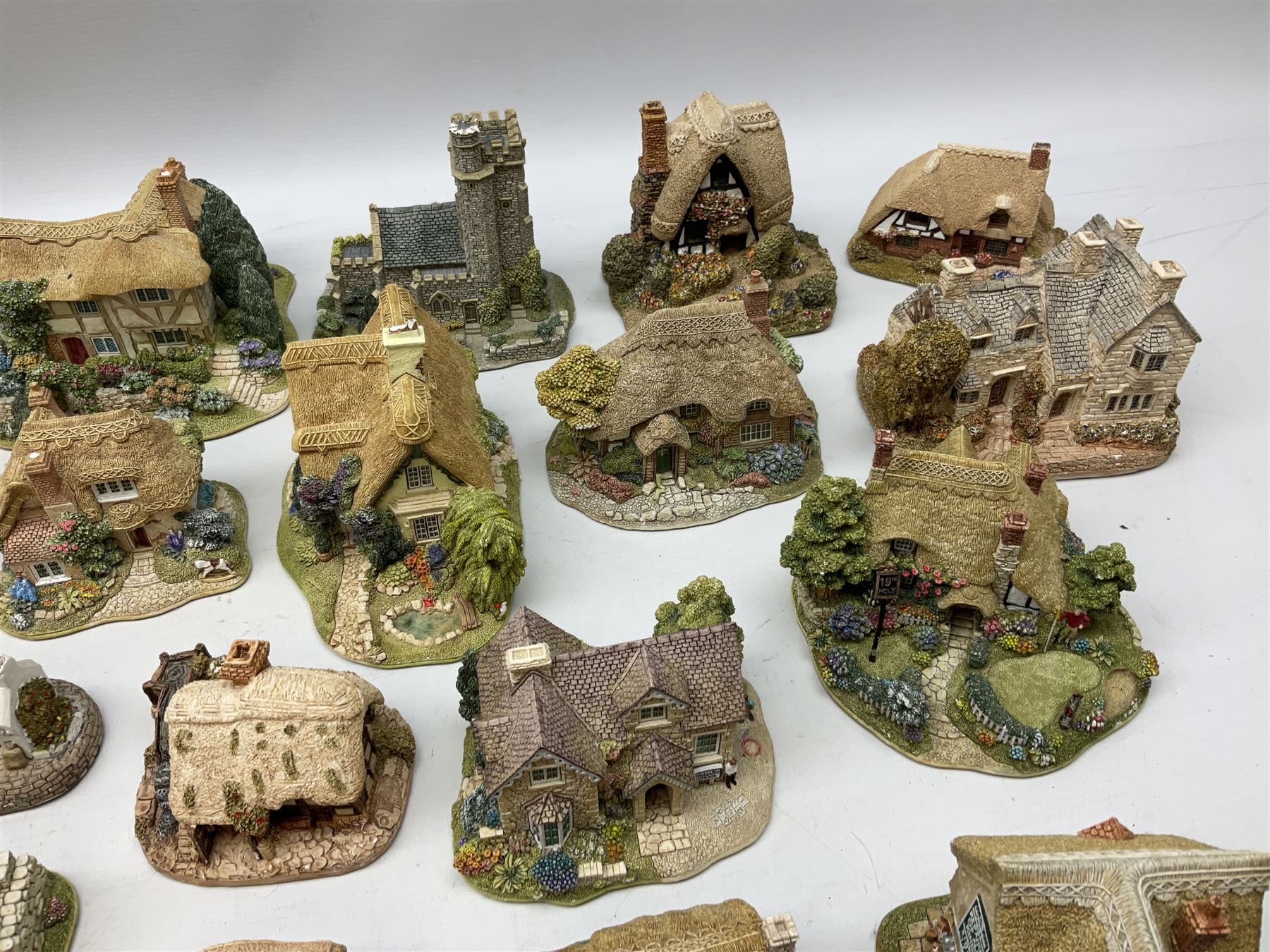Forty six Lilliput Lane model cottages, to include 'Convent in the Woods', 'Holme Dyke' 'Secret Garden' etc