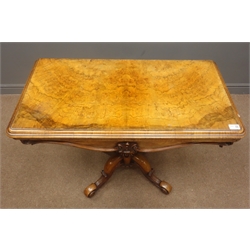  Victorian figured walnut card table, rectangular folding top with circular green baize inset, octagonal baluster column, four splayed supports with acanthus scroll carved feet, on brass castors, W93cm, H78cm, D92cm  
